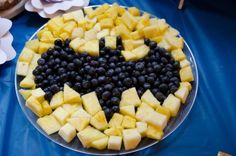 a heart shaped fruit platter with blueberries and pineapples