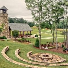 an aerial view of a stone building with a clock tower in the background and landscaping around it