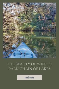 a blue kayak floating on top of a lake next to trees and water with the words, the beauty of winter park chain of lakes