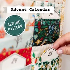 a person is holding up a sewing calendar