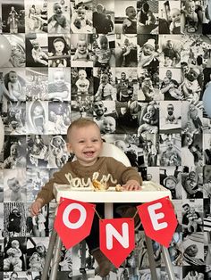 a baby sitting in a high chair with a one sign on it's side