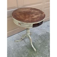 an old wooden table sitting in front of a garage door