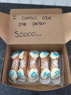 a box filled with frosted donuts sitting on top of a counter next to a sign that says i cannot ask one person 500