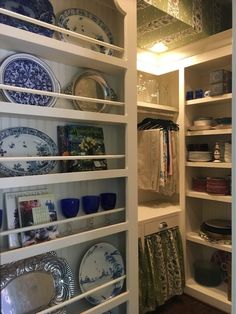 an open pantry with plates and bowls on the shelves, dishes are sitting on top of each other