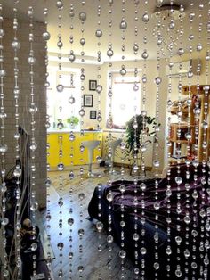 a bedroom with lots of bubbles hanging from the ceiling, and a bed in front of it