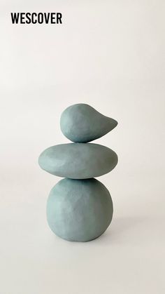 a stack of rocks sitting on top of each other in front of a white background