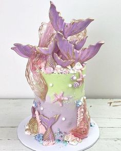 there is a cake decorated with purple and green decorations