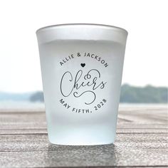 a shot glass with the names and date printed on it