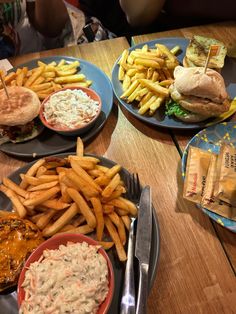 several plates of food on a wooden table