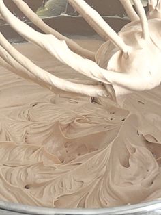 a bowl filled with white frosting sitting on top of a counter