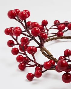 a bunch of red berries sitting on top of a white table