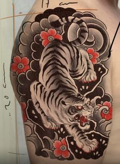 a man with a tiger tattoo on his back