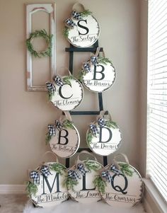 a christmas tree made out of plates with monogrammed letters and wreaths on them