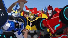 an animated image of several robots in front of a blue sky and some red and yellow