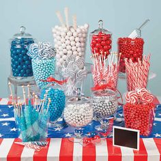 a table topped with lots of candy and lollipops on top of it