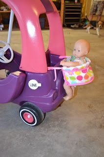 a baby sitting in a purple toy car