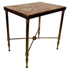 a small table that is made out of wood and metal with an intricate design on the top