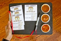 a person holding a pen and pointing to some food items on a tray with two small bowls