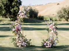 an outdoor ceremony setup with flowers and greenery