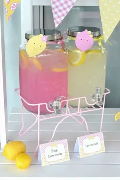 there are two jars with lemonade and lemonade on the table next to each other