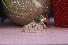 a tiara ring sitting on top of a table next to a christmas ornament