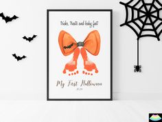 a halloween card with an orange bow on it and bats hanging from the wall behind it