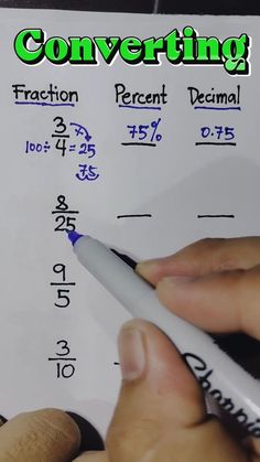 someone is writing on a piece of paper with numbers and fractions written in it