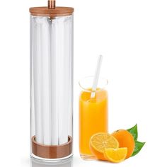 an orange juicer next to a glass filled with oranges and a straw in it