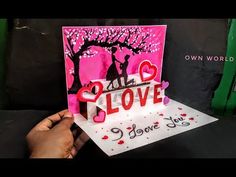 someone holding up a card that says all love