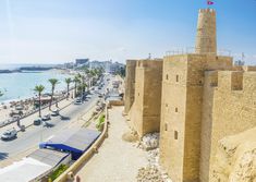 an aerial view of the old city walls and beach in front of the ocean on a sunny day