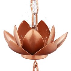 a large metal flower with water droplets on it