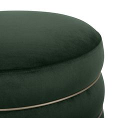 a green velvet ottoman with gold trim around the top and bottom, on a white background