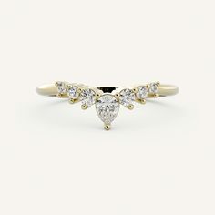 a yellow gold ring with three pear shaped diamonds