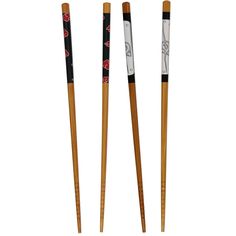 three wooden chopsticks with designs on them