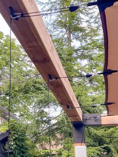 an outdoor dining area with tables, chairs and umbrellas hanging from the roof above