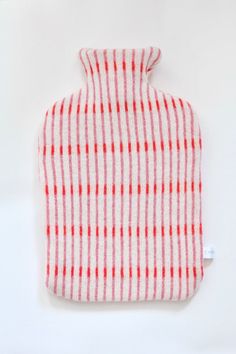 a red and white checkered oven mitt sitting on top of a white table