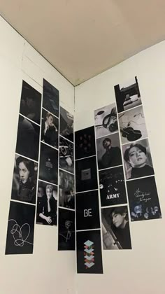 an open book with black and white photos on it's cover, hanging from the ceiling