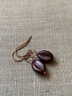 Rainbow Coffee Bean Bead Rose Gold Filled Earrings.  A beautiful addition to my coffee bean collection, these lovely earrings are the perfect pick me up for the coffee lover.  I have complemented these fun purpley brown rainbow coffee bean beads with rose gold filled findings, as I think that they are the perfect match. Each coffee bean bead is 11mm x 8mm in size. The approximate length of the earrings is 16mm, not including ear fittings. The 3mm ball headed studs are shown in the last photograp Coffee Bean Stud Earrings, Handmade Coffee Colored Jewelry For Gifts, Handmade Coffee-colored Jewelry For Gift, Brown Rainbow, Coffee Bean Earrings, Rainbow Coffee, Funky Jewelry, Gold Filled Earrings, Lovely Earrings