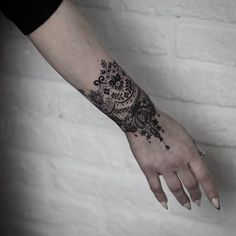 a woman's hand with a tattoo on it