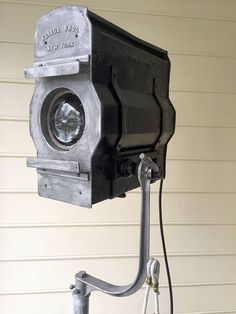 an old camera mounted to the side of a house