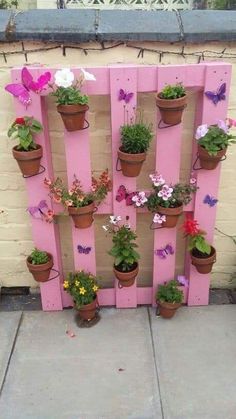 a pink pallet filled with potted plants