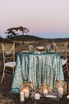 a table set up with candles and plates