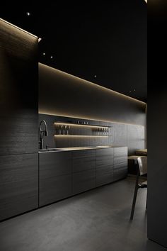 a modern kitchen with black cabinets and counter tops, along with an illuminated bar area