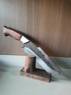 a large knife on top of a wooden block