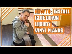 a woman sitting on top of a wooden floor next to an orange sign that says how to install glue down luxury vinyl planks