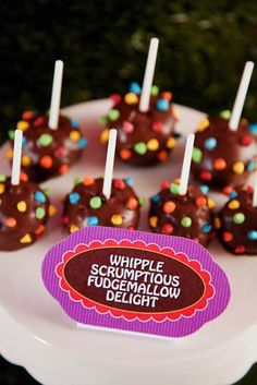 chocolate covered candies with sprinkles and candy stickers on a plate