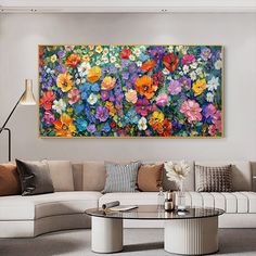 a living room filled with furniture and a large painting on the wall over a coffee table