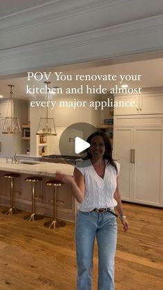 a woman standing in front of a kitchen counter with an appliance on it