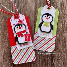 two tags with penguins on them are hanging from the string, and one has a tag that says be merry