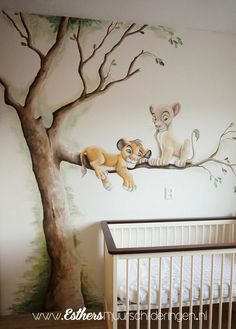 a baby's room with a lion mural on the wall and a crib